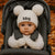 Baby in a stroller wearing a white knit hat with 'Meg' embroidered on it.
