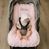 Baby in a stroller with a pink pram liner personalised 