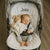 Baby sleeping in a stroller with a bunny tag blanket, with 'Jake' personalised on the white pram liner