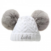 White beanie with gray pom-poms and 'Luka' embroidery on a white background