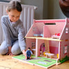 Girl Playing With A Dolls House