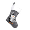 Gray Christmas stocking with a penguin design on a white background