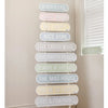 A vertical, multi-colored signpost stands against a white wall and window blinds. Each sign has a different phrase: "BEACH PLEASE," "BEST MUM," "BEE HAPPY," "NICE BUM," "LIVE LAUGH WOOF," "OUR HAPPY PLACE," "BEWARE OF THE KIDS," "THE MAD HOUSE," and more. A smaller sign reading **"Love Story and Love Life Love Life Street Sign 45cm - Bee Happy."**