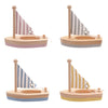 Four New Bambino Draft Bambino Wooden Sailing Boats with striped sails. Each New Bambino Draft toy has a different color scheme: pink with a pink and white striped sail, gray with a gray and white striped sail, blue with a blue and white striped sail, and yellow with a yellow and white striped sail—perfect for nursery decor.