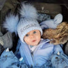 baby boy wearing a Personalised Blue double Pom Hat 