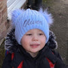 toddler boy wearing a Personalised Blue double Pom Hat 