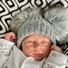 Baby boy wearing a Personalised Grey Pom Pom Hat