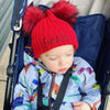 PersonalisBaby Boy wearing a Personalised Red Double Pom Hat 