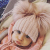 baby girl wearing a Personalised Rose Gold Pom Pom Hat