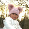 baby girl wearing a Personalised Rose Gold Pom Pom Hat