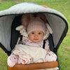 baby girl wearing a Personalised Rose Gold Pom Pom Hat