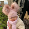 baby girl wearing a Personalised Rose Gold Pom Pom Hat