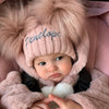 baby girl wearing a Personalised Rose Gold Pom Pom Hat