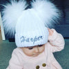 Baby wearing a Personalised White Double Pom Hat 