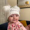 Baby wearing a Personalised White Double Pom Hat