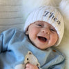 Baby wearing a Personalised White Double Pom Hat